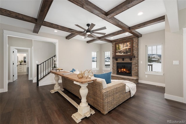 living room with a healthy amount of sunlight, dark hardwood / wood-style flooring, and coffered ceiling