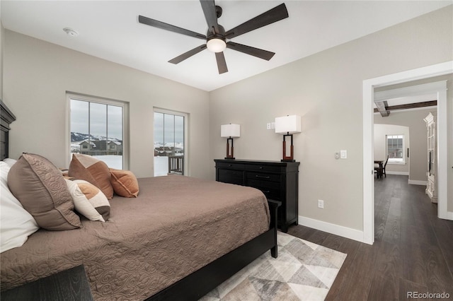 bedroom with ceiling fan, dark hardwood / wood-style floors, and beam ceiling