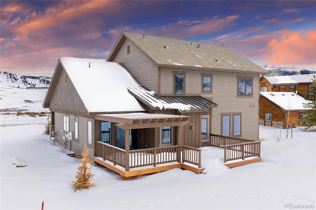 view of snow covered rear of property