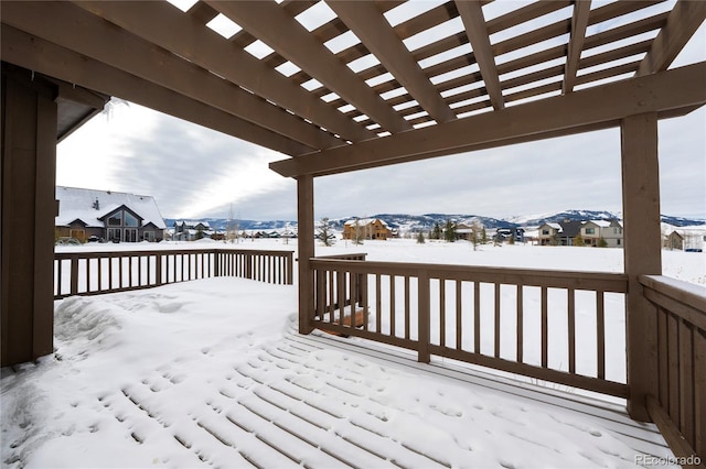 snow covered deck with a pergola