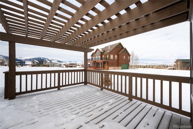 snow covered deck featuring a pergola