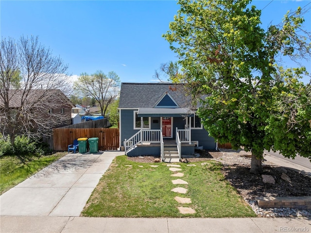 view of front of home with concrete driveway, a shingled roof, and covered porch