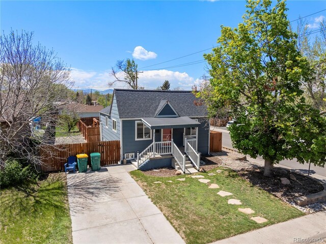 bungalow-style home featuring a shingled roof and driveway
