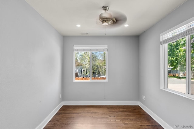 spare room with baseboards, dark wood finished floors, recessed lighting, and a ceiling fan