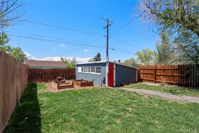 view of yard featuring a vegetable garden and an outdoor structure