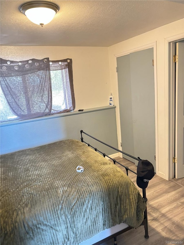 428 Prospect Ave, La Junta, CO 81050 - bedroom with a textured ceiling and wood finished floors