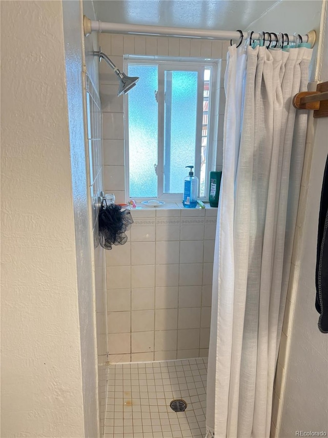 428 Prospect Ave, La Junta, CO 81050 - full bathroom featuring a textured wall and a stall shower