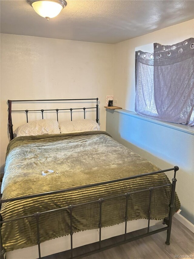 428 Prospect Ave, La Junta, CO 81050 - bedroom with baseboards and wood finished floors