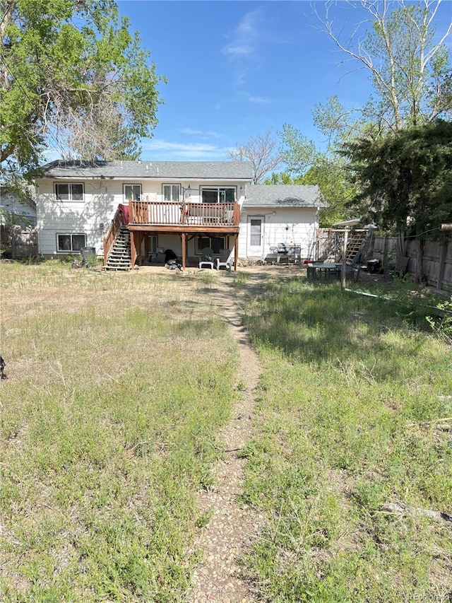 428 Prospect Ave, La Junta, CO 81050 - rear view of house featuring fence, stairs, and a deck