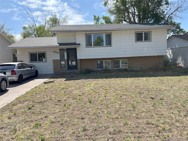428 Prospect Ave, La Junta, CO 81050 - split level home with brick siding and a front yard
