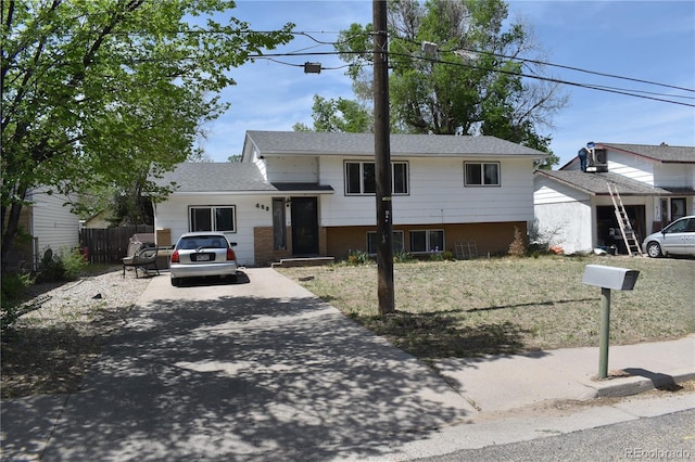 428 Prospect Ave, La Junta, CO 81050 - tri-level home featuring fence, concrete driveway, and brick siding