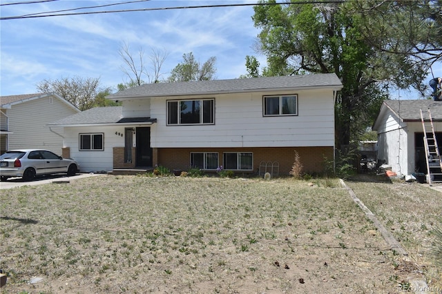 428 Prospect Ave, La Junta, CO 81050 - split level home featuring a front lawn and brick siding