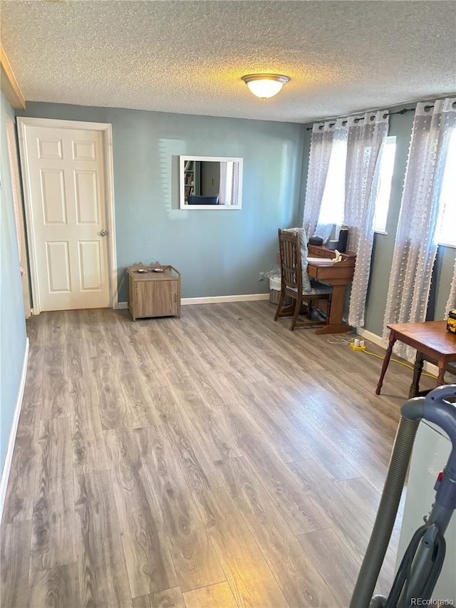 428 Prospect Ave, La Junta, CO 81050 - home office featuring baseboards, a textured ceiling, and wood finished floors