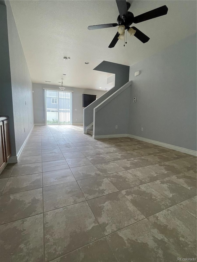 5537 Malta St, Denver, CO 80249 - unfurnished living room featuring stairs, baseboards, and a ceiling fan