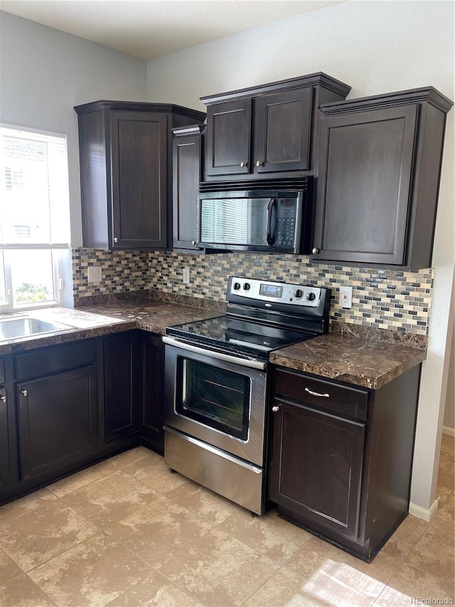 5537 Malta St, Denver, CO 80249 - kitchen featuring electric range, black microwave, decorative backsplash, and dark countertops