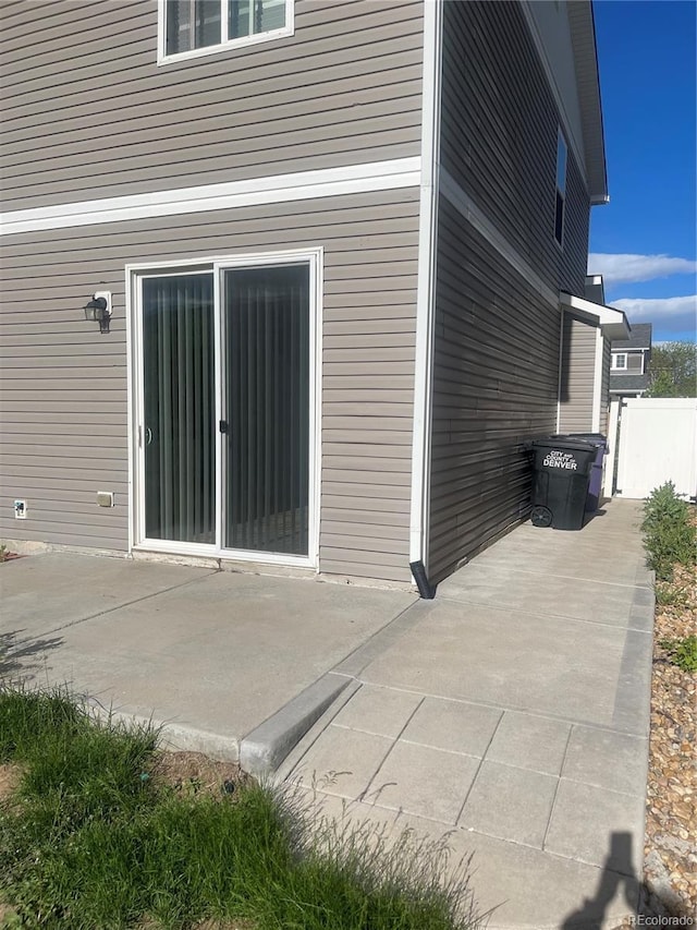 5537 Malta St, Denver, CO 80249 - view of property exterior featuring a patio area and fence