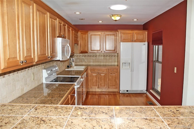 kitchen featuring a sink, white appliances, tasteful backsplash, tile countertops, and visible vents