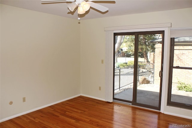 entryway featuring baseboards, a ceiling fan, visible vents, and wood finished floors