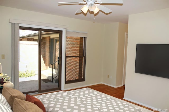 interior space featuring baseboards, a ceiling fan, and wood finished floors