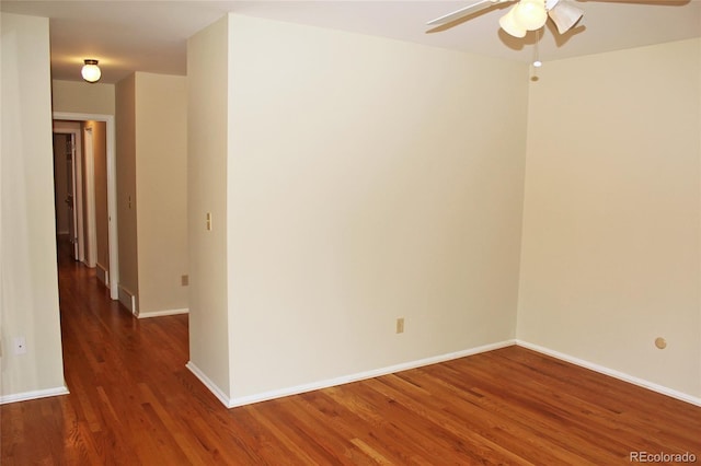 unfurnished room with wood finished floors, baseboards, and ceiling fan