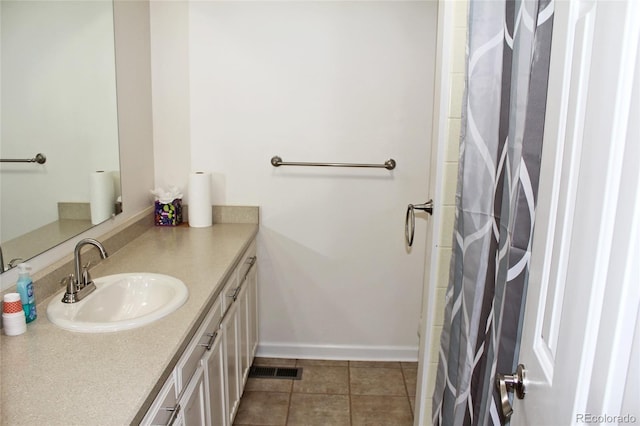 bathroom with baseboards, tile patterned flooring, vanity, and a shower with curtain