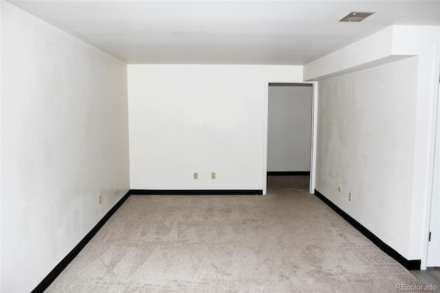 carpeted empty room with baseboards and visible vents