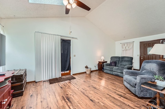 4162 S Dunkirk Way, Aurora, CO 80013 - living area featuring ceiling fan, vaulted ceiling, hardwood / wood-style floors, and a textured ceiling