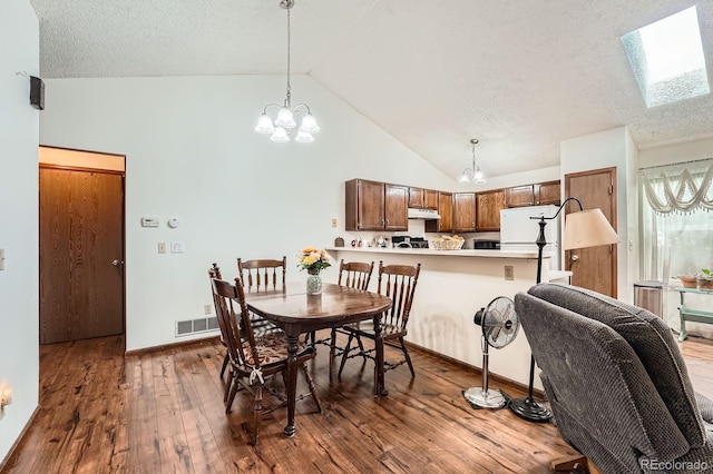 4162 S Dunkirk Way, Aurora, CO 80013 - dining space with hardwood / wood-style floors, a skylight, a chandelier, high vaulted ceiling, and a textured ceiling
