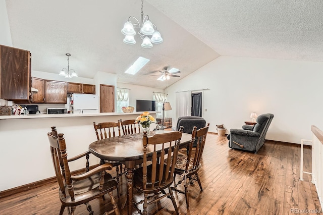 4162 S Dunkirk Way, Aurora, CO 80013 - dining area with a chandelier, lofted ceiling, hardwood / wood-style flooring, a textured ceiling, and ceiling fan