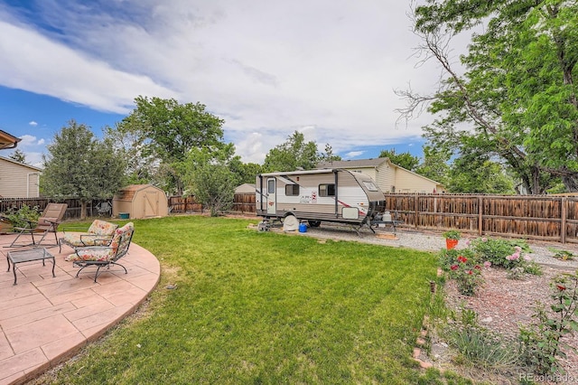 4162 S Dunkirk Way, Aurora, CO 80013 - fenced backyard with a storage unit and a patio area
