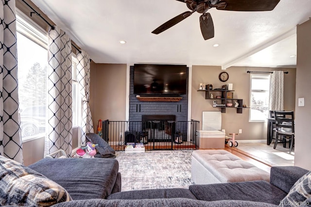 tiled living room with a ceiling fan, recessed lighting, a fireplace, and baseboards