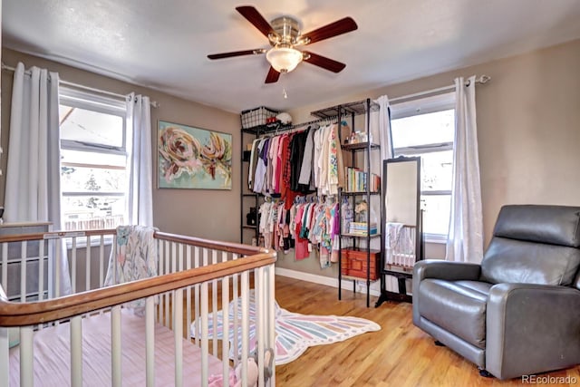 bedroom with wood finished floors, baseboards, and ceiling fan