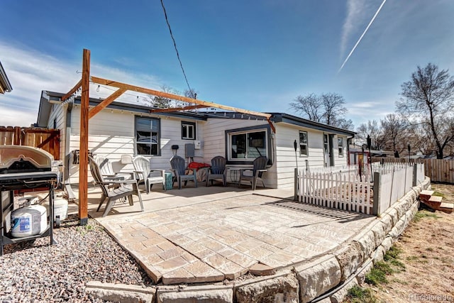 back of property with a patio area and fence