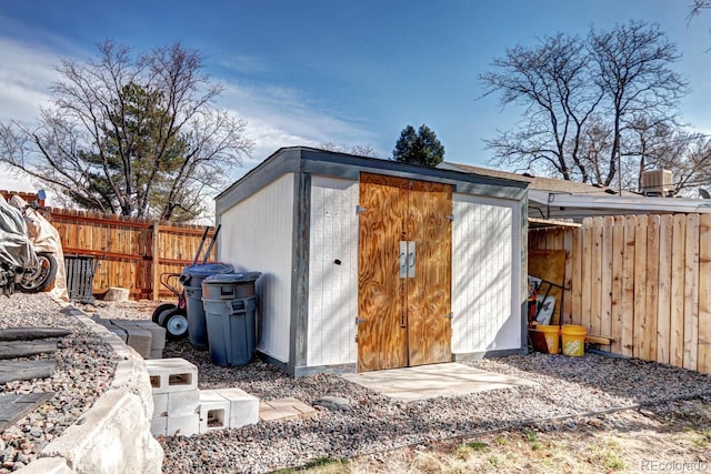 view of shed with a fenced backyard