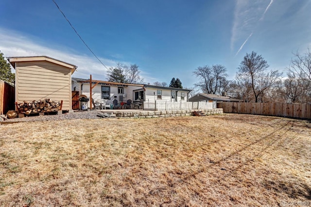 rear view of house featuring a patio area and fence