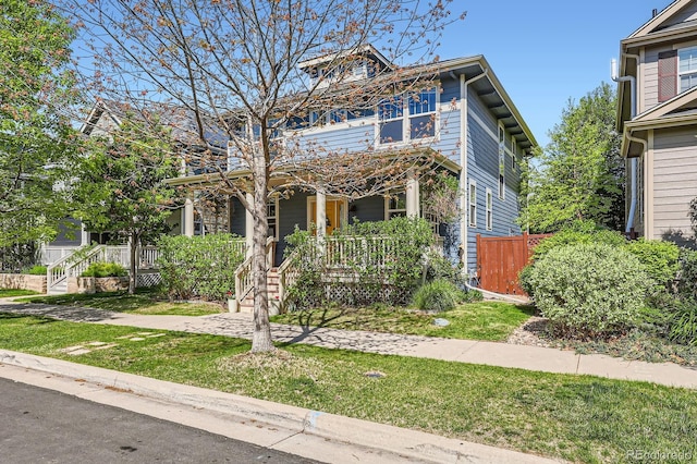 3386 Beeler Ct, Denver, CO 80238 - american foursquare style home featuring a porch and a front lawn