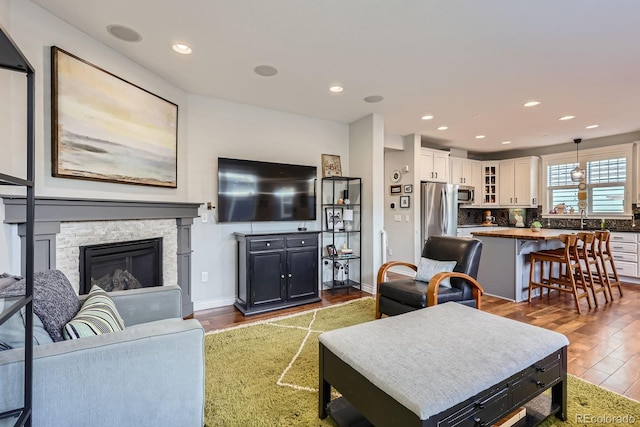 3386 Beeler Ct, Denver, CO 80238 - living area with wood finished floors, a fireplace, recessed lighting, and baseboards