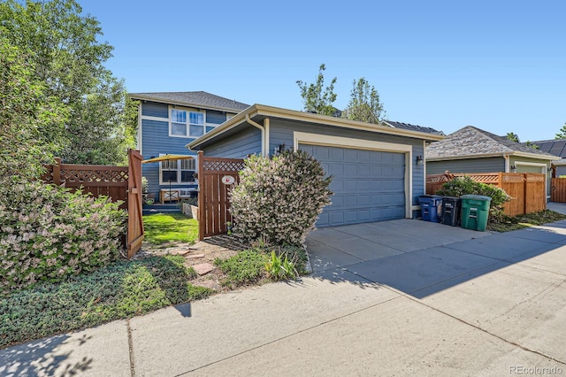 3386 Beeler Ct, Denver, CO 80238 - ranch-style house featuring fence, concrete driveway, and a garage