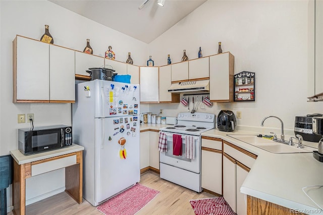 kitchen with white appliances, sink, and white cabinets