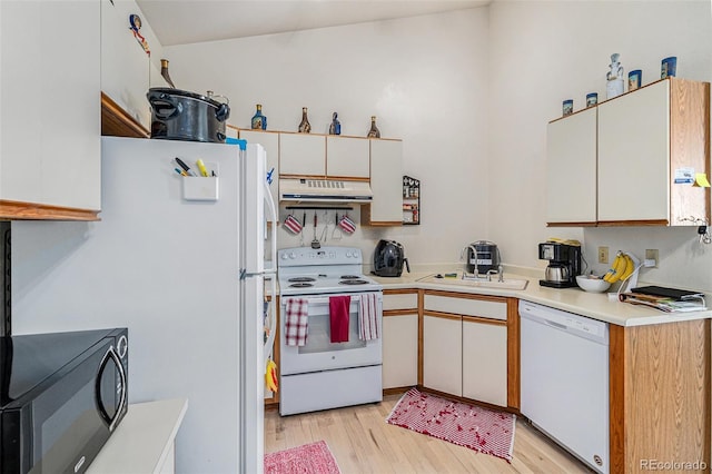 kitchen featuring white appliances, sink, light hardwood / wood-style flooring, and white cabinets