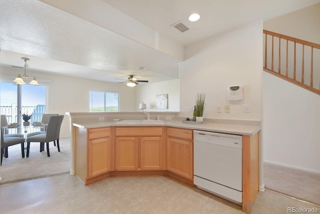 kitchen featuring light carpet, pendant lighting, light brown cabinetry, white dishwasher, and sink