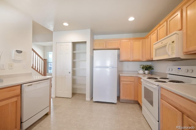 kitchen with white appliances and light brown cabinetry