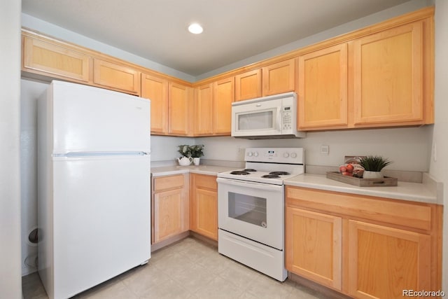 kitchen featuring white appliances and light brown cabinets