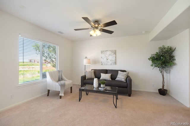 carpeted living room featuring ceiling fan