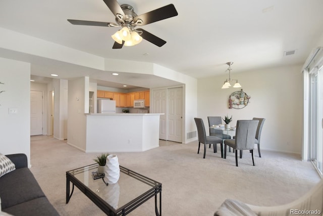 carpeted living room with ceiling fan