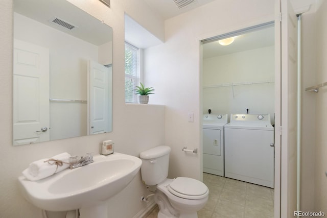 bathroom featuring sink, toilet, and washer and dryer