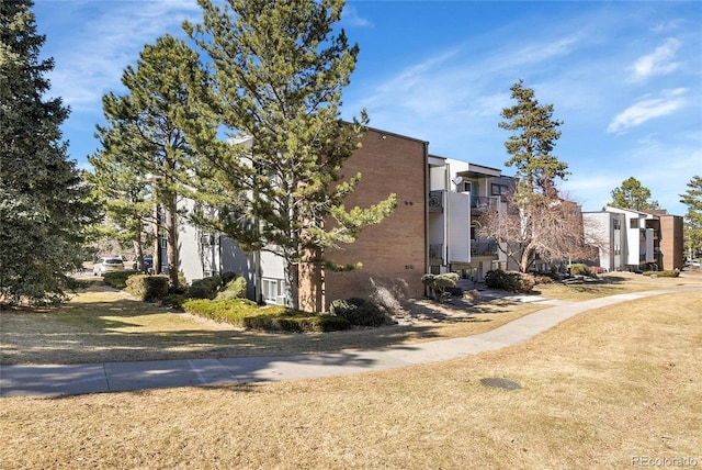 view of side of property featuring brick siding and a residential view