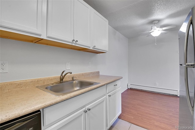 kitchen with a baseboard heating unit, a sink, white cabinets, and dishwasher