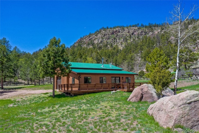 437 Langnis Rd, Guffey, CO 80820 - back of property featuring a deck with mountain view and a forest view