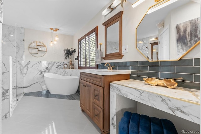 bathroom featuring tile patterned floors, vanity, shower with separate bathtub, and tile walls